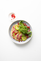 Sliced winter pink radishes on plate top view light surface