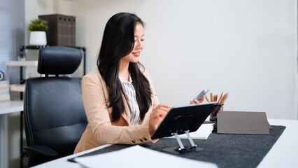 Businesswoman working at digital tablet in office
