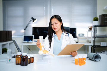 Asian Woman Doctor at Desk with Spinal Model tablet in Clinic for Healthcare Treatment Analysis and Patient Education Explaining Diagnosis