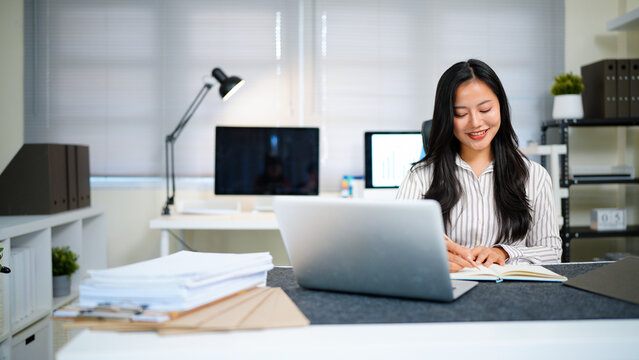 Writing, planning and computer with business woman in office, audit results and economy graph. Tax deadline, account manager and digital report with person in agency for budget review