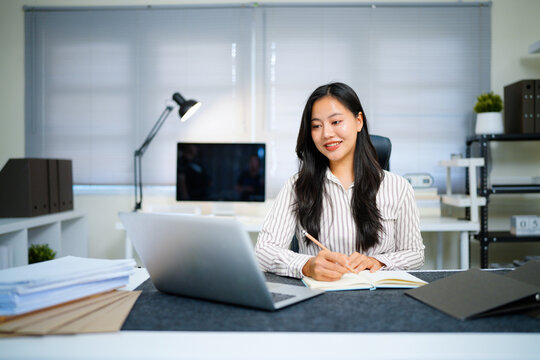 Writing, planning and computer with business woman in office, audit results and economy graph. Tax deadline, account manager and digital report with person in agency for budget review