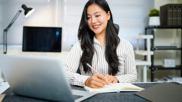 Writing, planning and computer with business woman in office, audit results and economy graph. Tax deadline, account manager and digital report with person in agency for budget review