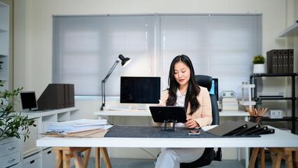 young woman using pad computer for business app. Busy executive CEO businesswoman professional holding digital tablet pc device for work in modern office workplace.