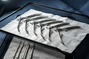 Sterile stainless steel nail care instruments on a medical tray. Close-up