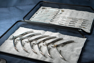 Sterile stainless steel nail care instruments on a medical tray. Close-up