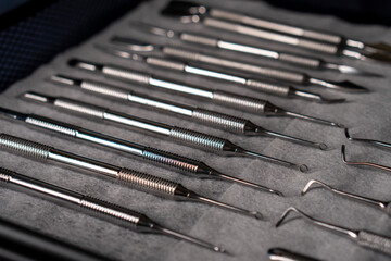 Sterile stainless steel nail care instruments on a medical tray. Close-up