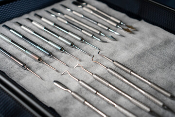 Sterile stainless steel nail care instruments on a medical tray. Close-up