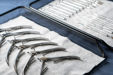 Sterile stainless steel nail care instruments on a medical tray. Close-up
