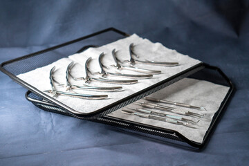 Sterile stainless steel nail care instruments on a medical tray. Close-up