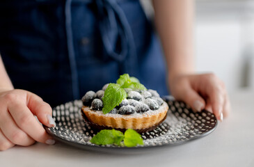 Girl Holding Blueberry Dessert