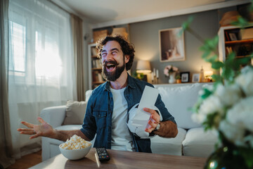 Man cheering watching sports and celebrating a betting win
