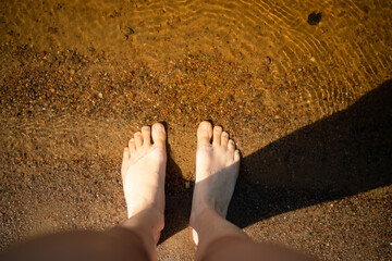 Woman feet relaxing in warm sunlight, embodying the comfort and tranquility of a peaceful moment.