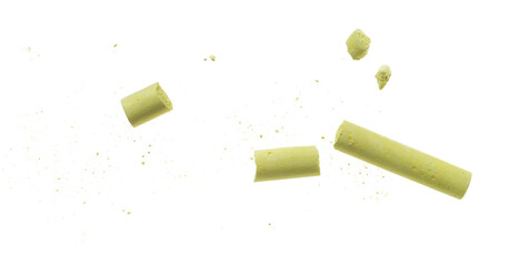 Broken yellow chalk with pieces flying, isolated on white background, clipping path, design, transparency