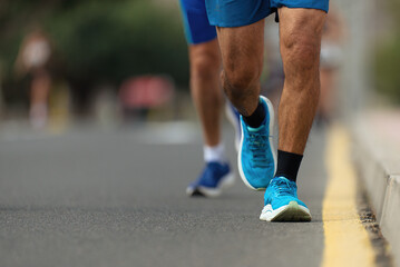 Marathon running race, people feet on city road	