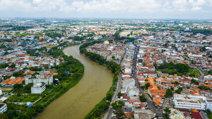 Calm river flowing through Tangerang City, Banten, Indonesia, highlighting a peaceful urban nature scene. © red.io