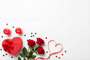 Romantic Valentine's Day setup with heart shaped gift box roses and candles on white background