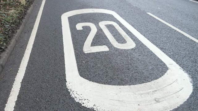 4K: 20mph Speed Zone Warning Sign markings on Road in the United Kingdom. Traffic management. Stock Video Clip Footage