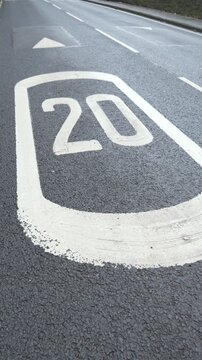 4K: 20mph Speed Zone Warning Sign markings on Road in the United Kingdom. Traffic management. Vertical. Stock Video Clip Footage