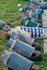 Old milk cans in a row. Carbide shooting or carbidschieten in dutch is a tradition in the Netherlands and usually takes place on New Year's Eve. The goal is to make a loud bang after the carbide