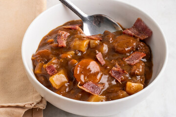 bowl of beef stew  with bacon bits
