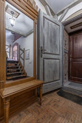 Vintage Hallway Interior with Wooden Door and Mirror Bench