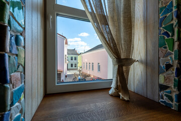 Window View of European Street with Soft Curtains and Natural Light