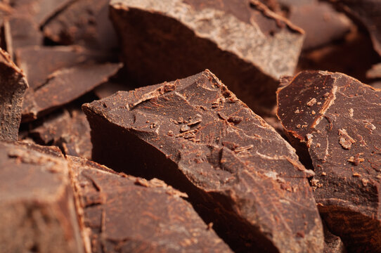 Rich dark chocolate chunks with a textured surface, close-up view