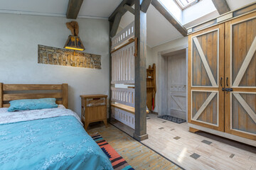 Rustic bedroom interior with wooden furniture and skylight
