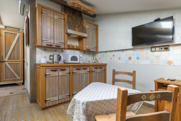 Rustic kitchen interior with wooden cabinets and dining area