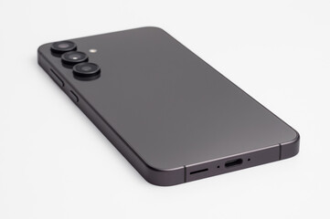 Modern dark gray smartphone with triple camera array on a clean white background