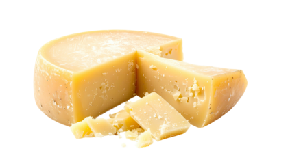 A wheel of creamy cheese, with a wedge cut out and a few small pieces around