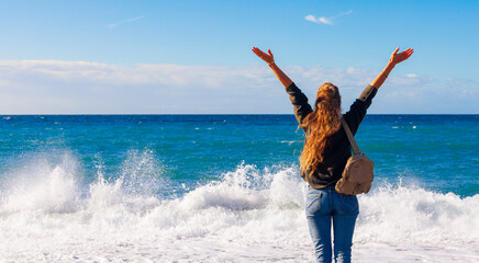 Woman celebrating freedom by the sea