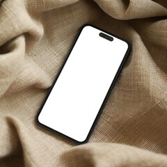 Smartphone with a blank white screen lying on textured linen fabric. Black device placed diagonally, soft natural light, close-up view with large clear screen area suitable for copy space.