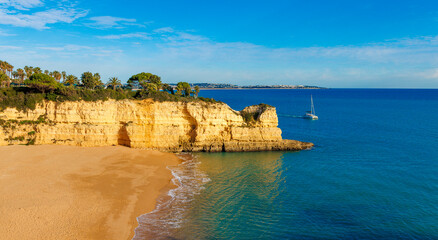 beautiful beach and golden rocks by the sea, Algarve in Portugal