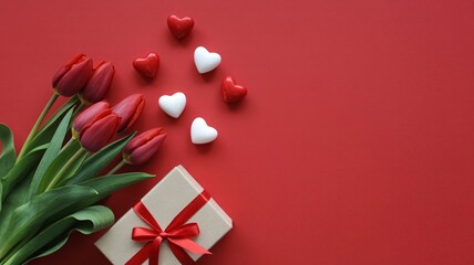 Valentine's day gift box with tulips and hearts on red background flat lay arrangement for romantic celebration with love