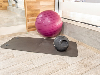 Home workout mat with exercise ball and kettlebell