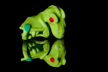 Toy Pterodactyl on a black glass background. © nedomacki