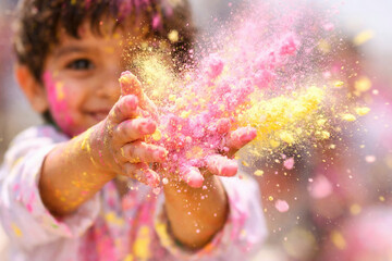 Joyful child embracing holi celebration with colorful powder and laughter