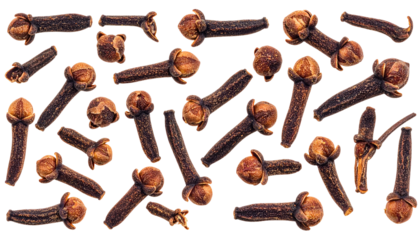 A close-up, overhead shot reveals a scattering of whole cloves, exhibiting a rich, dark brown hue. The spices are isolated against a stark, black background