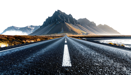 Asphalt road perspective towards distant majestic mountain range, clear sky, natural scenery
