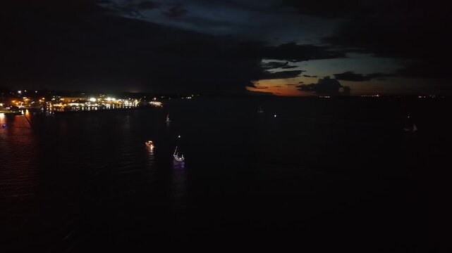 Nautical parade at dusk with storm clouds over Posadas, Argentina