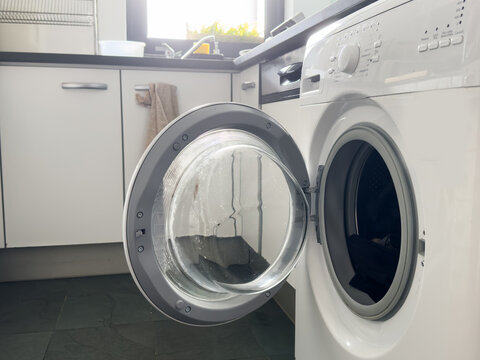 Washing machine with empty drum as background, closeup