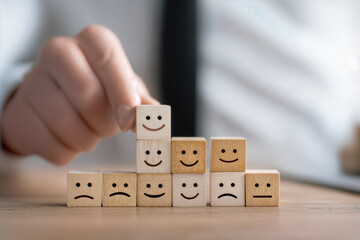 Customer Support Concept with Wooden Blocks Displaying Emotional Faces Illustrating Service