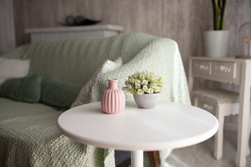 White round table with pink vase in cozy bright living room, furniture catalog, home decor marketing