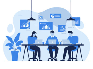 Business team working together on laptops at office desk with graphs and charts