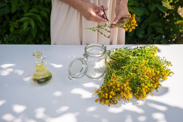 St. John's Wort Oil Recipe Step 3: Woman Arranging Hypericum Flowers