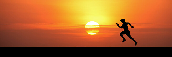 A silhouette of a runner set against a vibrant sunset sky, symbolizing ambition and perseverance....