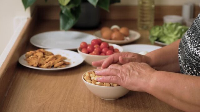 Mixing crunchy croutons for preparing Caesar salad. Stirring bread cubes for making fresh dish. Shuffling toasted pieces for Caesar recipe. Preparing crispy ingredient for vegetable mix