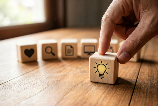Design Thinking Process concept. Wooden blocks with icons; the key stages of the design thinking process, a solution-focused, problem-solving methodology used for innovation and strategic development.
