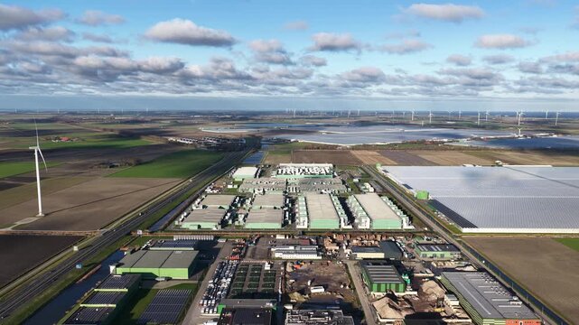 Aerial view of the AI Data Center with wind turbines and solar panels, bathed in the winter sun, a marvel of technology, Middenmeer, Netherlands.